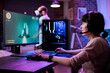 © DC Studio - Modern gamer streaming online multiplayer video games play on computer, enjoying shooting gameplay tournament. Female streamer playing action rpg game competition on pc monitor.