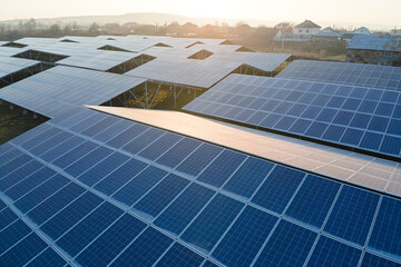 Aerial view of large sustainable electrical power plant with rows of solar photovoltaic panels for producing clean ecological electric energy. Renewable electricity with zero emission concept.