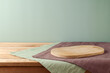 © maglara - Wooden board on table with modern tablecloth. Kitchen mock up for design and product display