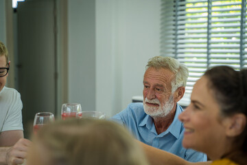 Senior man with wine glasses at home have lunch,Happy mature people having fun,Joyful elderly lifestyle concept.