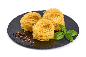 Italian pasta tagliatelle nest isolated on white background. Italian rolled fresh fettuccine pasta, isolated on white background.