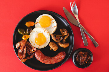 Hearty English breakfast with fried eggs and sausages