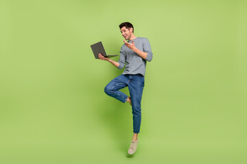 Wall Mural - Full body photo of cheerful businessman have video meeting with his colleagues isolated on green color background