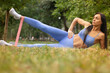 ©  QuantumMuse - Woman during fitness training in nature with resistance rubber band. Fitness gum