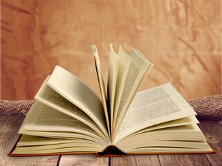 Wall Mural - A retro old book on a wooden table.