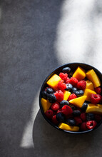 Colourful Fruit Salad With Pieces Of Mango, Raspberries And Blueberries