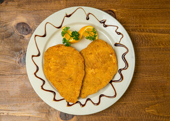 two chicken cutlets on a plate