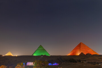 Wall Mural - The pyramids floodlit at night, Giza, Egypt