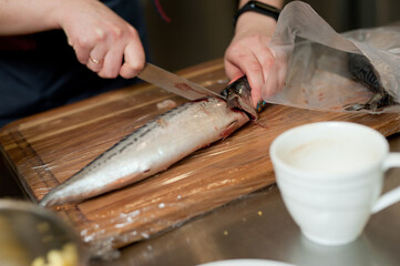 The cook separates the fillet from the fish and clears it from the bones. Mackerel fillets.