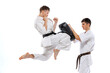 © master1305 - Two athletes, karate-do fighters in doboks practicing karate isolated on white background. Concept of sport, education, skills, martial arts, healthy lifestyle
