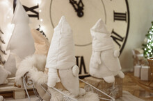Gnomes Plush Handmade On Background Of Large Clock. Christmas Interior.