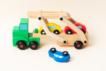 Toy tow truck towing damaged cars after a serious accident. Car traffic, car crash, dangerous incident.