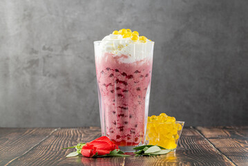 Wall Mural - Strawberry, lemon and bubble tea milkshake or smoothie on wooden table