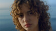 © stockbusters - Upset woman posing on camera at sea. Cheerful girl with serious face expression