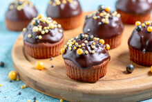 Chocolate Sponge Cakes Or Muffins With Chocolate Icing.