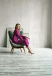 © velirina - Young businesswoman. Beautiful woman director, head, general manager, ceo in astylish bright business pink, fuchsia color suit at photoshoot in armchair. Business purposeful ambitious girl careerist