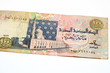 Obverse side of an old 100 LE EGP one hundred Egyptian cash money banknote features Al-Sayida Zainab mosque in Cairo at centre, selective focus of withdrawn Egyptian Pound banknotes isolated on white