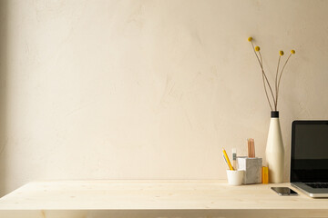 Wall Mural - Desk with notebook, desk objects, office supplies, books on a bright background.	
