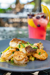 Wall Mural - A Seafood Trio of Crispy Skin Grouper, Shrimp and Scallops over Succotash.