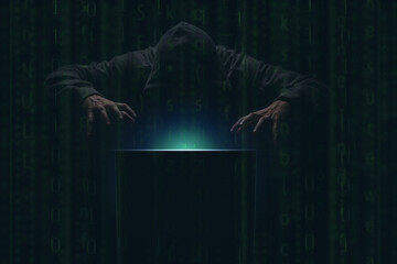 Wall Mural - hacker over a screen with green binary code. crime and information theft and computers