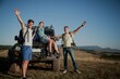 © BillionPhotos.com - Young happy adult friends on a hike with a car