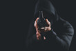 © Nunkung - Criminal holding machine gun pointing gun to target in front on dark background,selective focus on front gun.