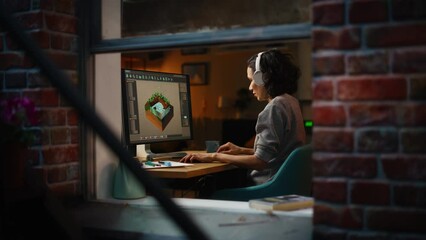 Aufkleber - Female Video Game Designer Works on a New 3D Level on Her Personal Computer. Focused Woman Creating Metaverse and Design Video Game. Shot Into the Apartment Window Late at Night
