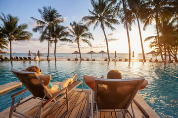 Wall Mural - vacation, couple on the beach near swimming pool, luxury travel