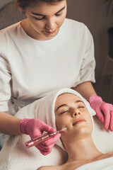 Wall Mural - cosmetologist carries out procedures of hydropeeling face. girl facial treatment. cosmetic beauty sp