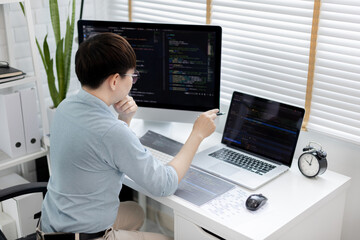 professional development programmers are laying out a structure or draft on paper in preparation for