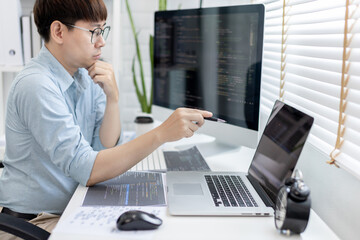 professional development programmers are laying out a structure or draft on paper in preparation for