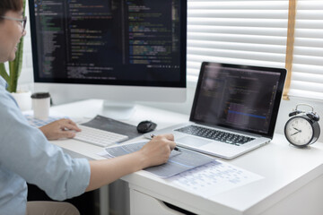 professional development programmers are laying out a structure or draft on paper in preparation for
