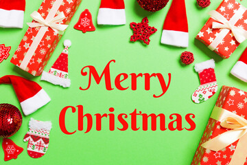 Sticker - Merry Christmas text. Top view of Christmas decorations on green background. New Year holiday concept with copy space