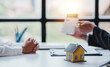 © Daenin - Real estate agents present and consult with clients to decide whether to sign an insurance contract. house trading About Mortgage and Home Insurance Offers