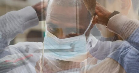 Poster - Composite video of african american man wearing face mask against caucasian boy studying at school