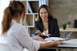 © Wasan - Female manager in office discussing and interviewing job applicant for new employees. Businesswomen and colleagues discussing and discussing work on business projects together.