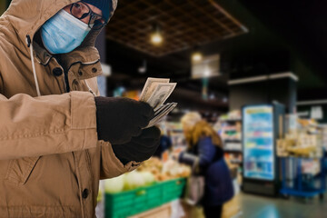 Canvas Print - Portrait of man in safety medical mask holding big cash money pack, elderly people during a pandemic