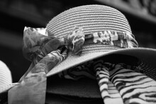 Female Wicker Hats With Different Bows For Sale. Paris, France. Retro Fashion Background. Summer Vacation, Beach Holidays Relaxation Concepts. Selective Focus And Bokeh. Black White Historic Photo.