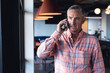 © WavebreakMediaMicro - Caucasian mature businessman talking on mobile phone in creative office