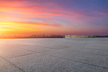 Empty Floor And Modern City Skyline With Sky Clouds At Sunset
