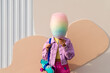 © VISTA by Westend61 - Woman covering face with cotton candy in front of wall