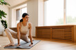 © Drobot Dean - Young white woman doing exercise on mat during yoga practice
