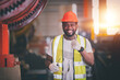 © Suriyo - Portrait African American Black afro worker in factory, Cameroon Black man employee work in  production plant manufacture factory industry and operator line machine steel metal using helmet for safety