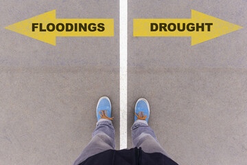 Wall Mural - Flooding or Drought choice, text on asphalt ground, feet and shoes on floor