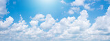 Fototapeta  - Abstract white puffy clouds and blue sky background.