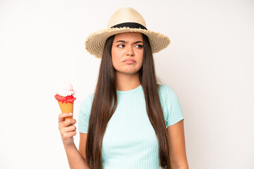 hispanic pretty woma covering mouth with hands with a shocked. ice cream and summer concept