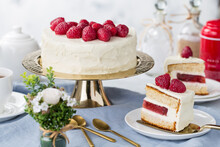 White Cake With A Wreath Made Of Raspberries On The White Background