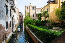 Boats Floating In The Calm Canals Of Venice, Italy.
