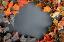 Autumn Decorative Wreath Of Branches And Red Leaves On A Gray Background. Copy Space, Flat Lay