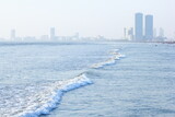 Fototapeta Sawanna - A beautiful picture of seaview wave with buildings karachi sindh. peoples of karachi.
